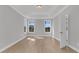 Light-filled bedroom with wood floors, tray ceiling, and large windows offering picturesque views at 701 Maynard Ln, Summerville, SC 29486