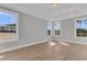 Bright bedroom featuring wood floors, recessed lighting, and large windows with views of the neighborhood at 701 Maynard Ln, Summerville, SC 29486
