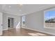 Sunlit bedroom with wood floors, tray ceilings, and an attached tiled bathroom and walk-in closet at 701 Maynard Ln, Summerville, SC 29486
