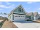 Charming coastal home featuring a two-car garage and light blue siding at 701 Maynard Ln, Summerville, SC 29486