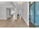 Bright foyer featuring wood floors leading to the living area with fireplace at 701 Maynard Ln, Summerville, SC 29486