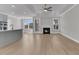 Open-concept living room with fireplace, ceiling fan, and natural light from windows at 701 Maynard Ln, Summerville, SC 29486