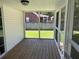 Back porch is screened in with wood floor and view of backyard at 732 Gahagan Rd, Summerville, SC 29485