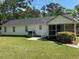Home's backyard with green lawn, patio, and a screened in porch at 732 Gahagan Rd, Summerville, SC 29485