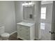 Bright bathroom featuring a white vanity with marble countertop and a decorative mirror at 732 Gahagan Rd, Summerville, SC 29485