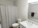 Bathroom features a shower with curtain, marble sink, and decorative mirror at 732 Gahagan Rd, Summerville, SC 29485