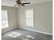 Large bedroom with ceiling fan, two bright windows, and neutral colored walls at 732 Gahagan Rd, Summerville, SC 29485