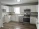 Bright kitchen features granite countertops, stainless steel appliances, and white cabinets at 732 Gahagan Rd, Summerville, SC 29485
