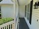 Covered porch with white railings and black shutters on white siding at 732 Gahagan Rd, Summerville, SC 29485
