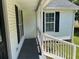 Welcoming porch with white railings and black shutters at 732 Gahagan Rd, Summerville, SC 29485