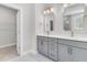 Bright bathroom featuring double sinks with quartz countertops, modern fixtures, and a walk-in closet at 739 Maynard Ln, Summerville, SC 29486