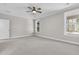 Bright and spacious bedroom featuring plush carpeting, neutral walls, a ceiling fan, and windows bringing in natural light at 739 Maynard Ln, Summerville, SC 29486