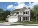 Charming two-story home with a symmetrical facade, manicured lawn, and attached two-car garage for modern convenience at 739 Maynard Ln, Summerville, SC 29486