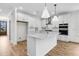 Modern white kitchen featuring a central island, stainless steel appliances, and sleek cabinetry, offering a contemporary design at 739 Maynard Ln, Summerville, SC 29486
