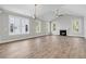 Spacious living room with vaulted ceilings, a cozy fireplace, hardwood floors, and large windows offering bright light at 739 Maynard Ln, Summerville, SC 29486