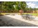 Outdoor dining area and a fire pit in a backyard with green grass and privacy fence at 74 Longleaf Dr, Walterboro, SC 29488