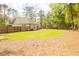 Large private backyard featuring a privacy fence, mature trees and lush green grass at 74 Longleaf Dr, Walterboro, SC 29488