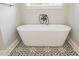 Elegant bathroom showcases a freestanding white bathtub with black vintage-style faucet and patterned tile flooring at 74 Longleaf Dr, Walterboro, SC 29488