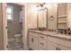 Bright bathroom featuring a dual sink vanity with a beautiful granite countertop and patterned tile floor at 74 Longleaf Dr, Walterboro, SC 29488