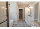 Modern bathroom with granite vanity, patterned tile floor, and glass enclosed shower at 74 Longleaf Dr, Walterboro, SC 29488
