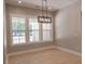 Dining room with large windows for natural light and modern light fixture at 74 Longleaf Dr, Walterboro, SC 29488
