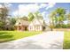 View of home featuring a long driveway, a side entry garage, and a nicely landscaped front yard at 74 Longleaf Dr, Walterboro, SC 29488