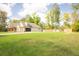 View of home featuring a spacious yard, attached garage, and rear fencing to provide privacy and seclusion at 74 Longleaf Dr, Walterboro, SC 29488