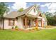 Exterior view featuring craftsman style columns, a stained wood front door and nicely manicured landscaping at 74 Longleaf Dr, Walterboro, SC 29488
