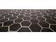 Close-up on stylish hexagon-patterned flooring with dark hexagon tiles and white grout, providing a modern look at 74 Longleaf Dr, Walterboro, SC 29488