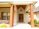 Covered front porch with craftsman style wood columns and decorative lighting at 74 Longleaf Dr, Walterboro, SC 29488