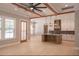Open concept kitchen and living area with ceiling fan and granite countertops at 74 Longleaf Dr, Walterboro, SC 29488