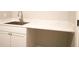Laundry room showcasing ample counter space, cabinets, and a stainless steel sink for efficient cleaning at 74 Longleaf Dr, Walterboro, SC 29488