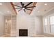 Living room features built in shelves, wood burning fire place, ceiling fan, and wood beams at 74 Longleaf Dr, Walterboro, SC 29488