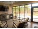 Screened outdoor living area featuring kitchen, lounging area, television, and fire pit at 74 Longleaf Dr, Walterboro, SC 29488