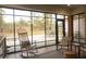 Relaxing sunroom with rocking chairs, a rug and a view of the brick patio at 74 Longleaf Dr, Walterboro, SC 29488