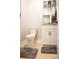 Stylish powder room with wood-look flooring, a granite vanity top, and modern fixtures, creating a comfortable space at 74 Longleaf Dr, Walterboro, SC 29488