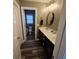 Hallway leading into bathroom with double vanity sinks and a separated toilet room at 7406 Purser Ln, Hanahan, SC 29410