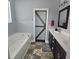 Bathroom featuring a tub, double vanity, and a barn door detail at 7406 Purser Ln, Hanahan, SC 29410
