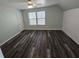 Neutral bedroom featuring a ceiling fan, windows, and vinyl flooring at 7406 Purser Ln, Hanahan, SC 29410