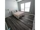 Bright bedroom featuring laminate floors, ceiling fan, and a comfortable bed at 7406 Purser Ln, Hanahan, SC 29410