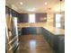 Open kitchen featuring stainless steel appliances, a large island and modern pendant lights at 7406 Purser Ln, Hanahan, SC 29410