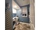 Functional laundry room with modern washer, dryer, storage, and ironing board at 7406 Purser Ln, Hanahan, SC 29410