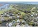 Stunning aerial view showcasing a waterfront community with lush greenery, trees, and ponds at 754 Summerwind Cir, Edisto Island, SC 29438