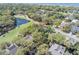 Aerial view of a home surrounded by mature trees, near a pond, and close to the beach at 754 Summerwind Cir, Edisto Island, SC 29438