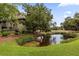 Beautiful home with a serene pond view surrounded by lush greenery and mature trees at 754 Summerwind Cir, Edisto Island, SC 29438
