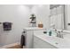 Bright bathroom features a white vanity, hardwood floors and decor shelves at 754 Summerwind Cir, Edisto Island, SC 29438