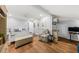 Bright bedroom features a bed, chair, hardwood floors, and neutral decor at 754 Summerwind Cir, Edisto Island, SC 29438