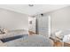 Bright bedroom with twin beds, white walls, wood floors, and a wicker chair at 754 Summerwind Cir, Edisto Island, SC 29438