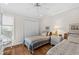 Charming bedroom with twin beds, neutral decor, wood floors, and ample natural light at 754 Summerwind Cir, Edisto Island, SC 29438