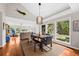 Open dining and living area with beautiful wood floors and large windows offering scenic views at 754 Summerwind Cir, Edisto Island, SC 29438